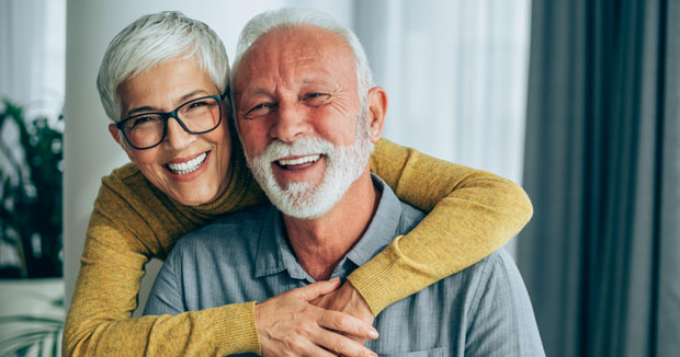 An older man and woman hugging