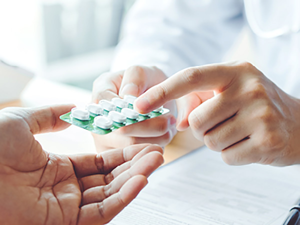Hands with pill packet