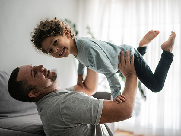 man holding young child in air