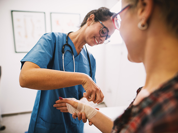 nurse bandaging a hand