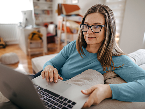 Woman wearing glasses with laptop
