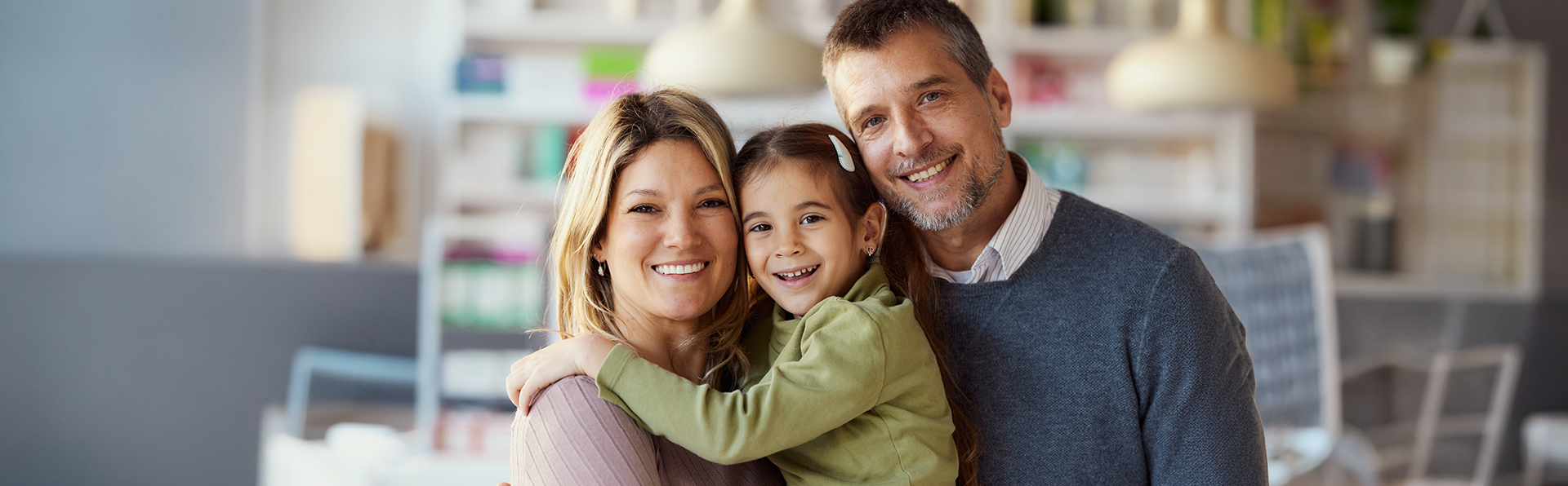 A young family hugging.