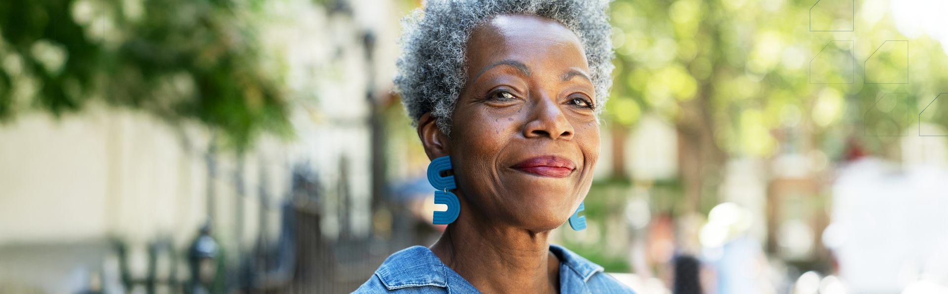 An older woman smiling outside