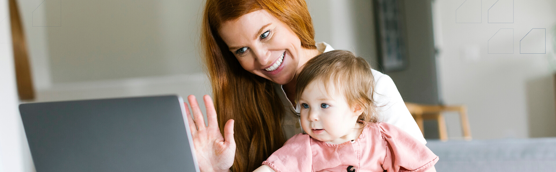 A mom and her infant child on a video visit on a computer.