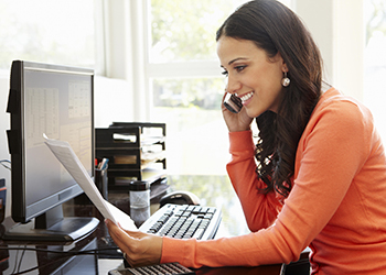 Woman smiling while talking on the phone