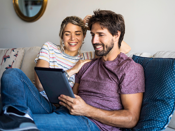 A young couple looking at an Ipad